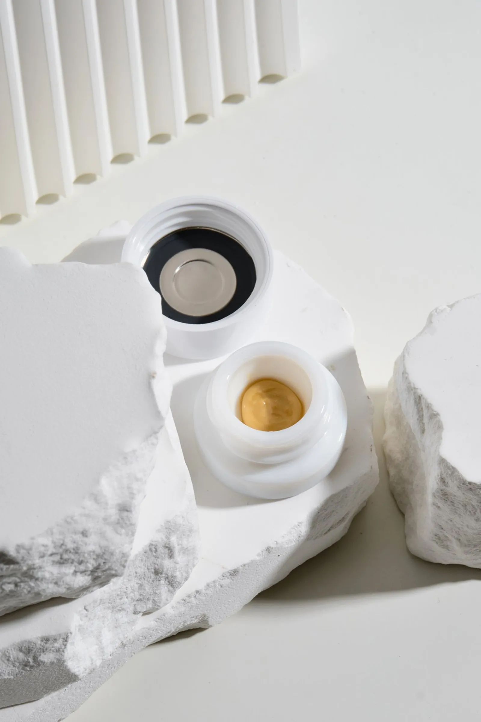 Two concentrate jars, one open to show the concentrate inside
