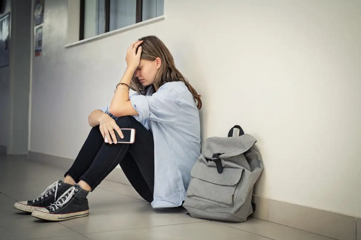 Woman sitting on the floor feeling depressed