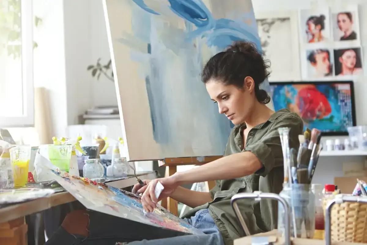 young female artist working on a painting