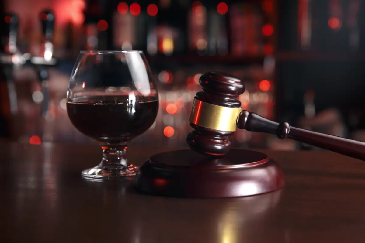 Alcohol and Gavel on the Table