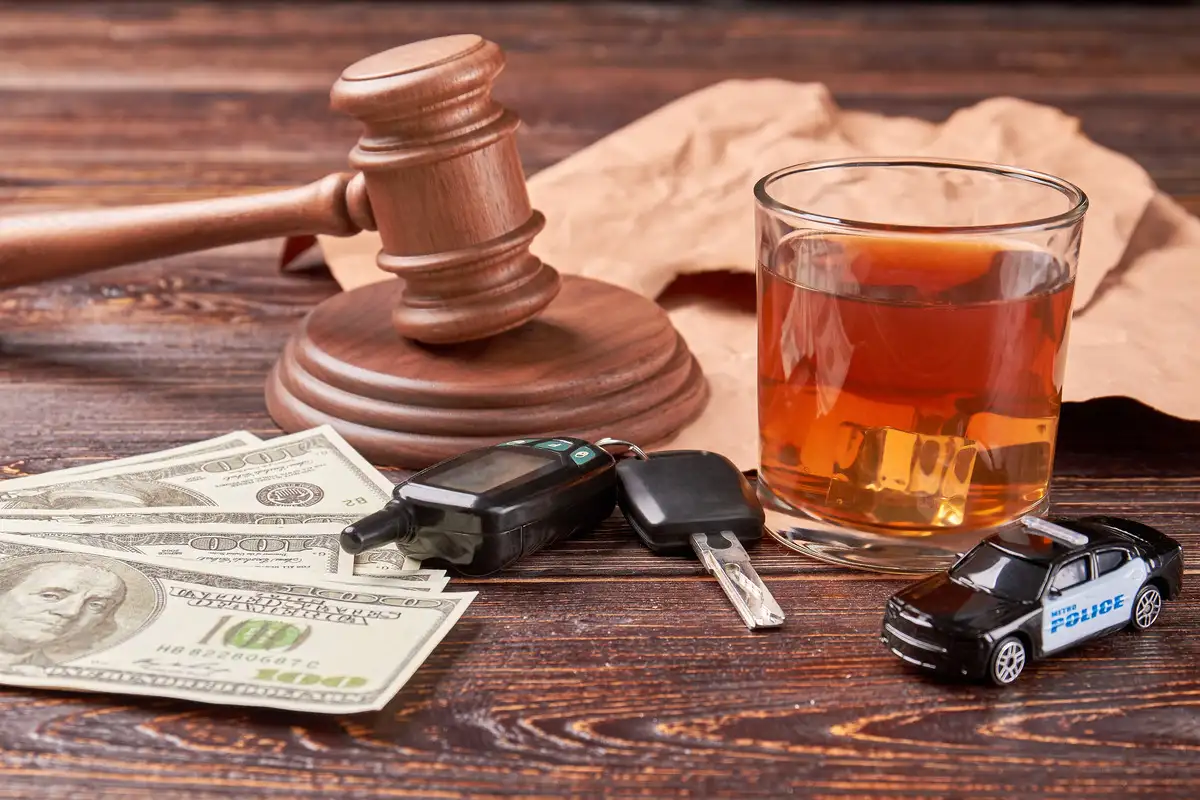 Judge's gaven, a glass of whiskey, and a car keys