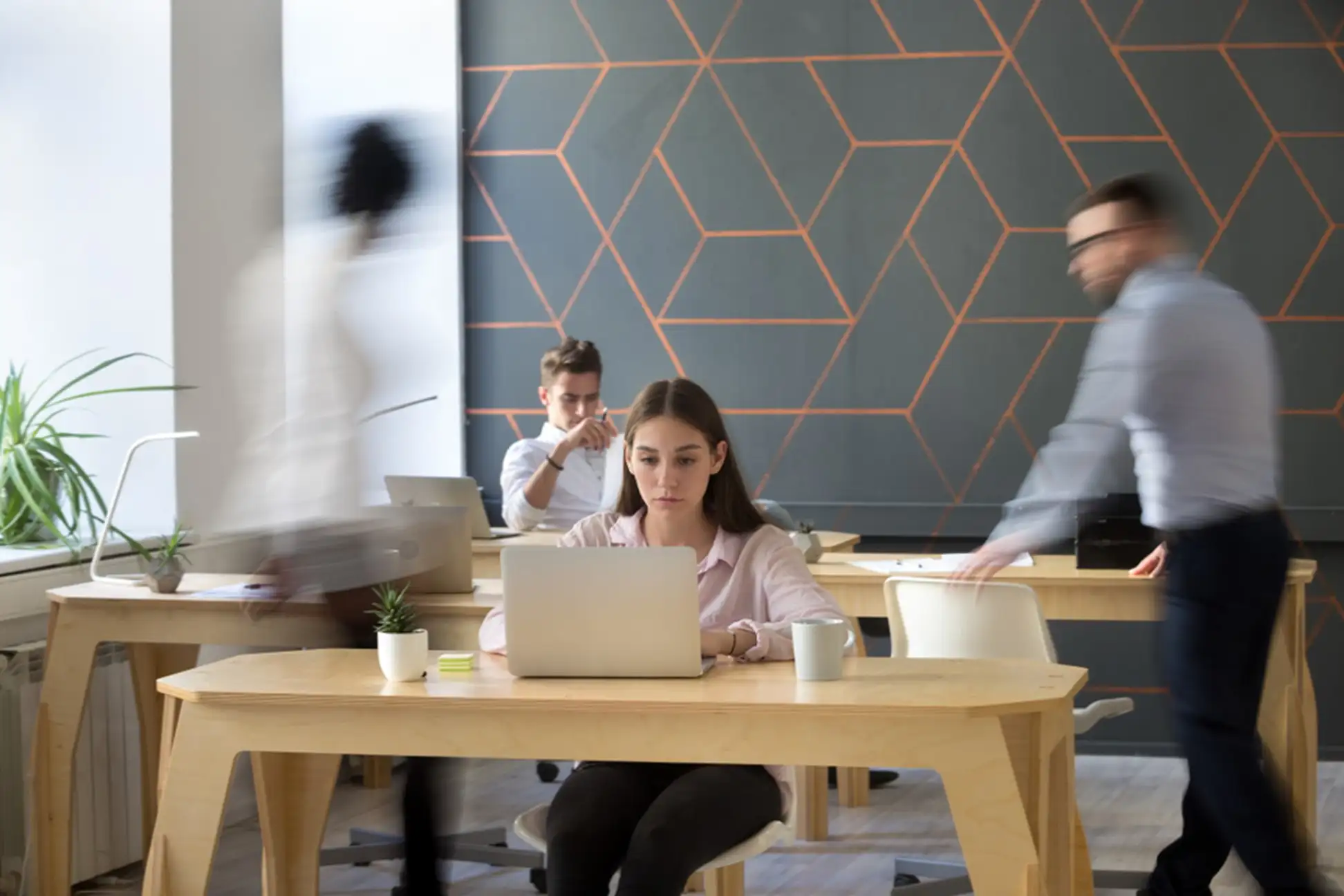 Woman sitting at a table with a laptop in front of her