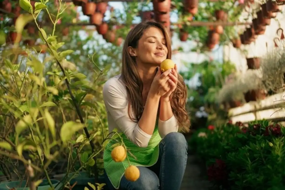 Woman smelling the lemon