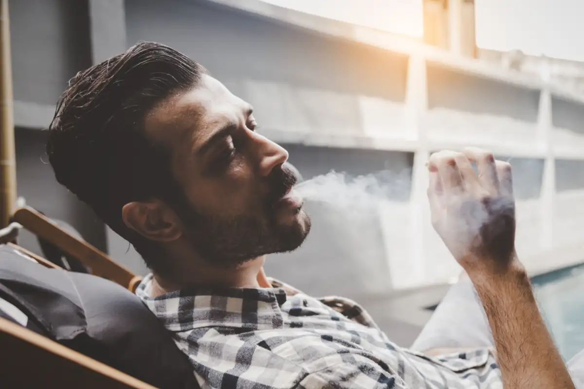 Young man smoking cannabis
