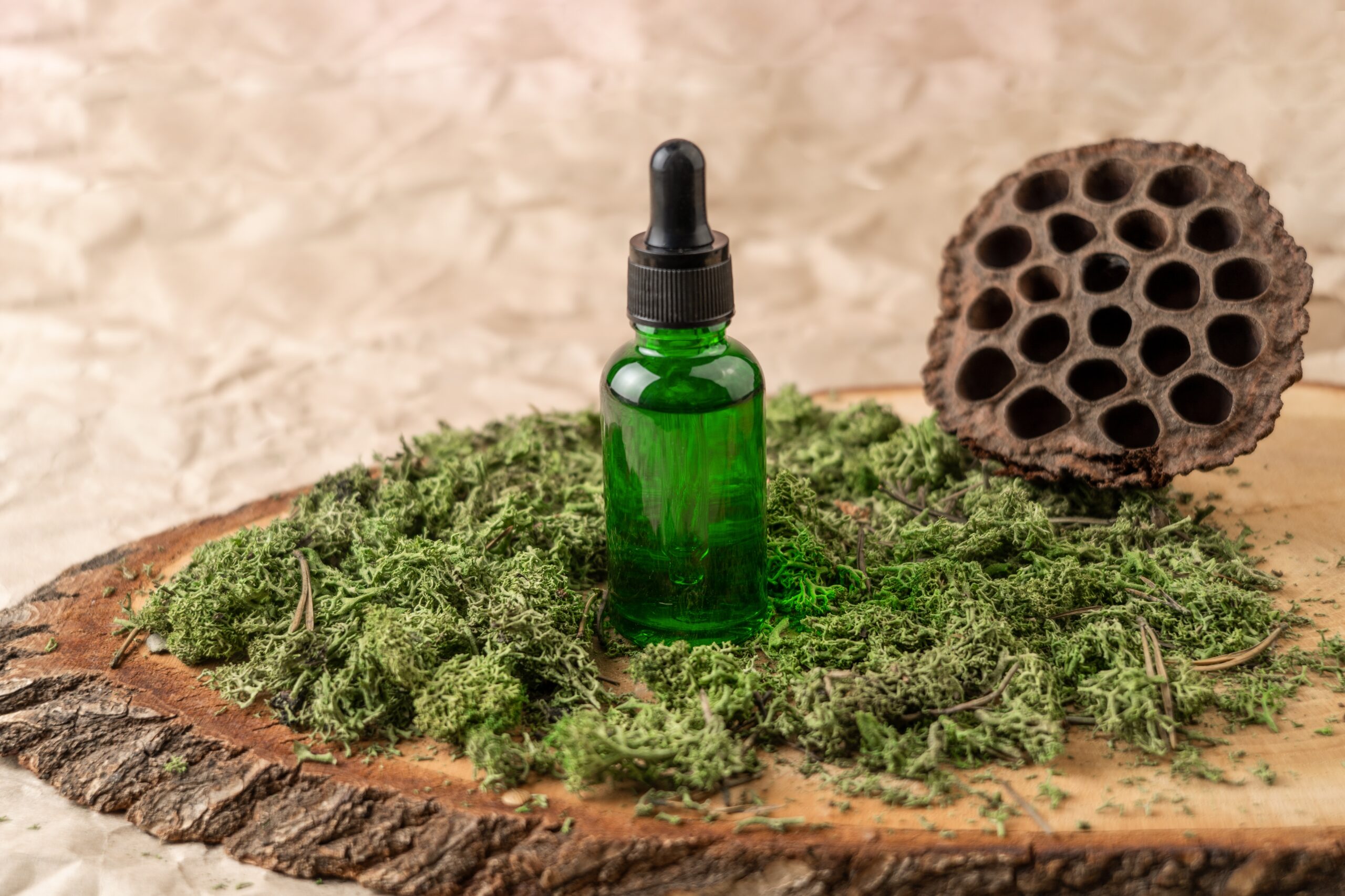 A green dropper bottle of face serum or natural oil standing on