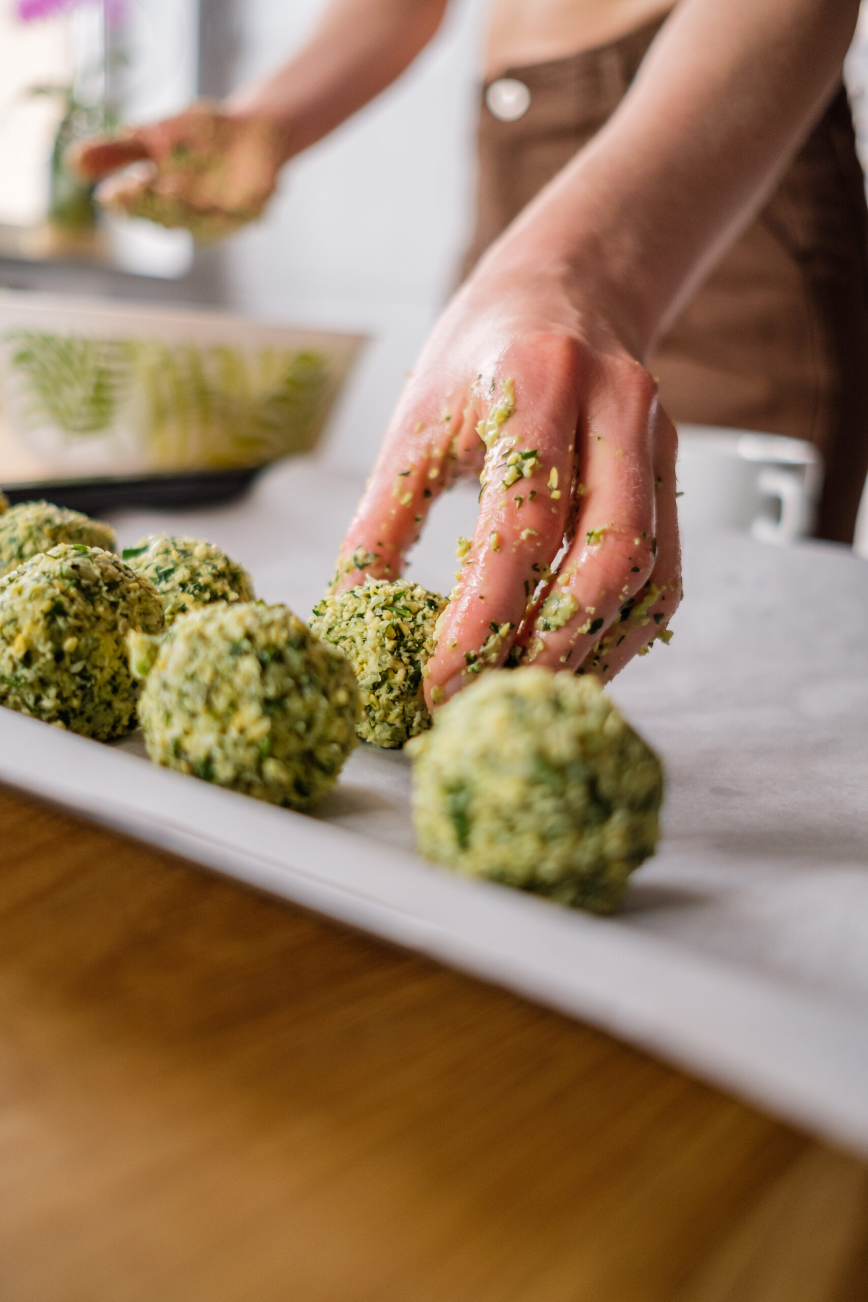 Beautiful woman cooking falafel on wooden table
