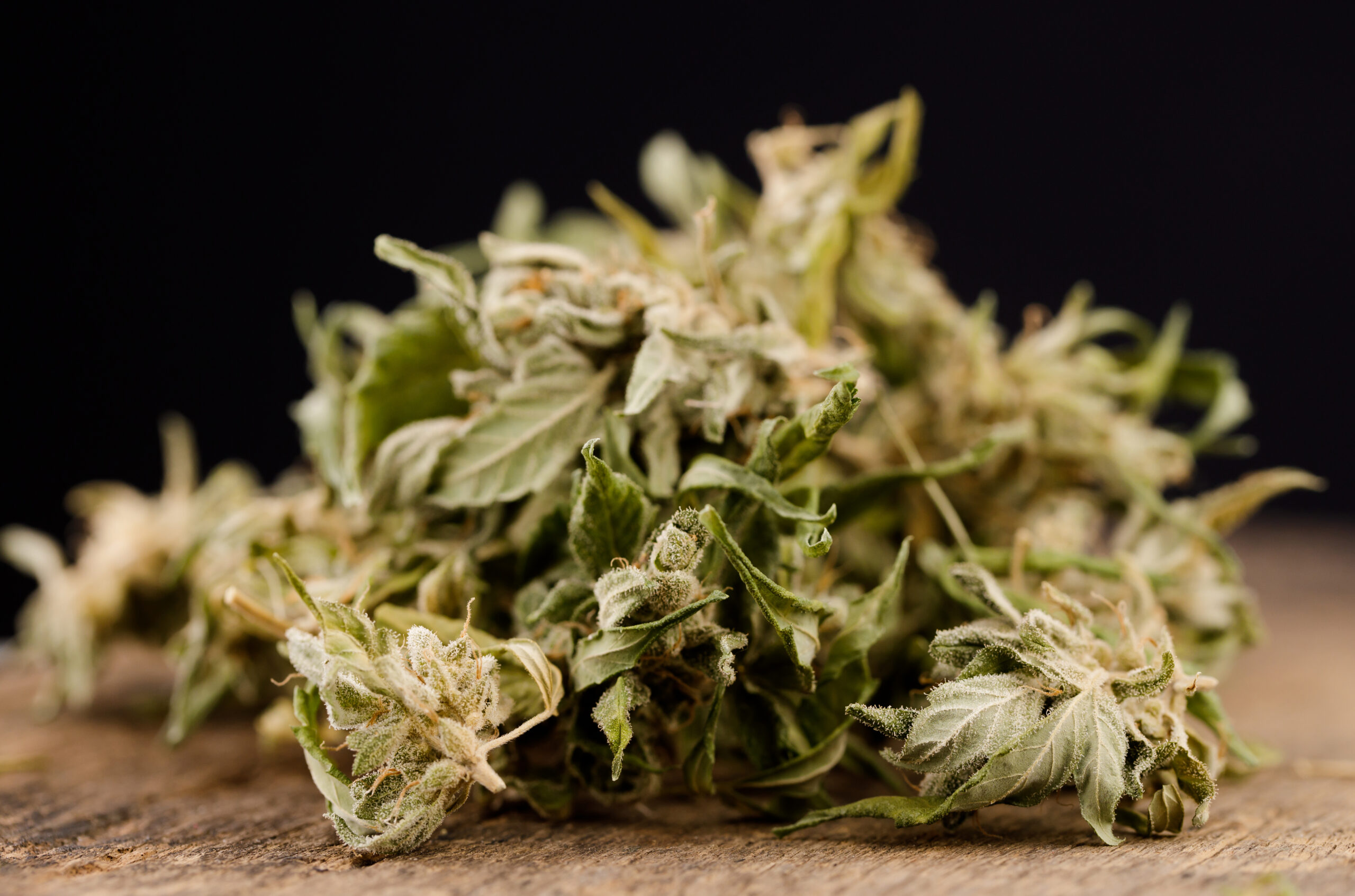 cannabis leaf on old wooden table