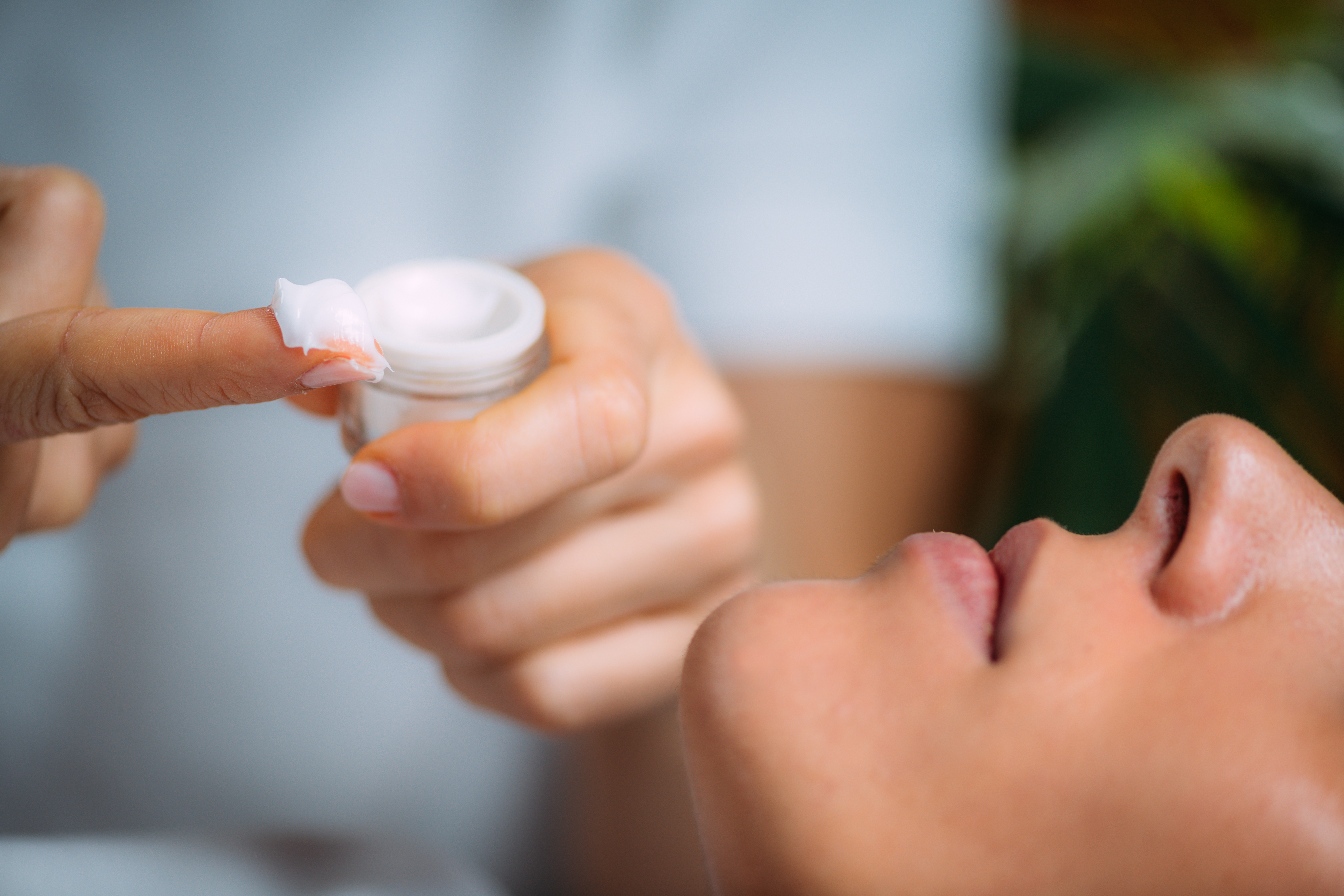 Cosmetician Applying Cream on Woman’s Face